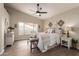 Cozy main bedroom with neutral tones, a ceiling fan, and lots of natural light at 8516 W Saint John Rd, Peoria, AZ 85382