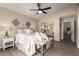 Lovely main bedroom featuring a ceiling fan, lots of pillows, and a bench at the foot of the bed at 8516 W Saint John Rd, Peoria, AZ 85382