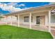 Charming covered patio and turfed backyard for leisure and entertaining at 8516 W Saint John Rd, Peoria, AZ 85382