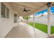 Spacious covered patio with ceiling fan and view of landscaped backyard at 8516 W Saint John Rd, Peoria, AZ 85382