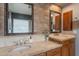 Bathroom featuring double sinks, tile backsplash, and decorative mirrors at 8703 E Nora St, Mesa, AZ 85207