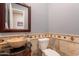 Powder room featuring stone basin sink, decorative backsplash, and granite countertop at 8703 E Nora St, Mesa, AZ 85207