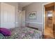 Bedroom featuring hardwood floors, closet and a window bringing in natural light at 8703 E Nora St, Mesa, AZ 85207