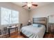 Well-lit bedroom with hardwood floors, a ceiling fan, and large window at 8703 E Nora St, Mesa, AZ 85207