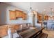 Eat-in dining area featuring custom wood cabinets and countertops, with a rustic wood dining table and chairs at 8703 E Nora St, Mesa, AZ 85207