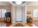 Inviting foyer with hardwood floors, neutral walls, and an elegant stone landing at 8703 E Nora St, Mesa, AZ 85207