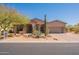 Charming single-story home with desert landscaping, including mature cacti and a paved driveway at 8703 E Nora St, Mesa, AZ 85207