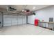 Spacious three-car garage with epoxy floor and plenty of storage space at 8703 E Nora St, Mesa, AZ 85207