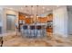 Spacious kitchen island with bar stool seating, wood cabinetry, and pendant lighting at 8703 E Nora St, Mesa, AZ 85207