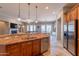 Open kitchen with a large island, stainless steel appliances, and hardwood floors at 8703 E Nora St, Mesa, AZ 85207