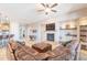 Open-concept living area with a fireplace, TV, and a luxurious leather sofa and ottoman at 8703 E Nora St, Mesa, AZ 85207
