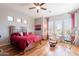 Comfortable bedroom with a ceiling fan, ensuite bath, and plenty of natural light at 8703 E Nora St, Mesa, AZ 85207