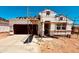 New construction home featuring a two-car garage and a modern architectural design at 11946 E Cliffrose Ln, Florence, AZ 85132