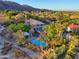 Aerial view of a home with a sparkling blue pool, mature landscaping, and mountain views at 12240 S Honah Lee Ct, Phoenix, AZ 85044