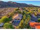 Aerial view of a beautiful home nestled in the desert with mountain views and palm trees at 12240 S Honah Lee Ct, Phoenix, AZ 85044