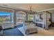 Serene bedroom with a four-poster bed, sitting area, and balcony access, offering a peaceful retreat with mountain views at 12240 S Honah Lee Ct, Phoenix, AZ 85044