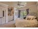 Bright primary bedroom boasts an oversized bed, chandelier, balcony access, and neutral color palette at 12240 S Honah Lee Ct, Phoenix, AZ 85044