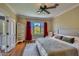 Bedroom featuring an upholstered bed, hardwood floors, neutral walls, red curtains, and mountain views at 12240 S Honah Lee Ct, Phoenix, AZ 85044