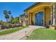 Stately entrance with stone walkway, arched entryway, and lush landscaping at 12240 S Honah Lee Ct, Phoenix, AZ 85044