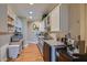 Bright kitchenette featuring stainless steel appliances, tile backsplash, custom cabinetry, and hardwood floors at 12240 S Honah Lee Ct, Phoenix, AZ 85044
