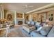 Spacious living room boasts a fireplace, plush seating, and detailed built-in shelving for a luxurious feel at 12240 S Honah Lee Ct, Phoenix, AZ 85044
