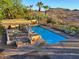 Relaxing pool area with ample lounge space and scenic mountain views at 12240 S Honah Lee Ct, Phoenix, AZ 85044