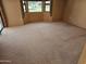 Spacious bedroom featuring neutral carpeting, bright windows, and fresh, inviting natural light at 12954 W Blue Sky Dr, Sun City West, AZ 85375