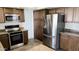 Well-lit kitchen featuring stainless steel appliances, granite countertops and ample storage space with traditional cabinets at 2132 E Chesapeake Dr, Gilbert, AZ 85234