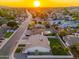 Beautiful aerial view of home with a lush green lawn, mature landscaping, and a stunning sunset at 2178 E La Jolla Dr, Tempe, AZ 85282