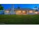 The backyard has a grassy lawn, covered patio, exterior lighting, and a fireplace at 2178 E La Jolla Dr, Tempe, AZ 85282