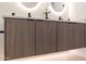 Close-up on bathroom vanity with stylish light wood cabinets and quartz countertops at 2178 E La Jolla Dr, Tempe, AZ 85282