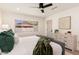 Bright bedroom with view to backyard featuring neutral tones and a modern ceiling fan at 2178 E La Jolla Dr, Tempe, AZ 85282