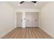Bedroom features light wood floors, modern ceiling fan, and a closet at 2178 E La Jolla Dr, Tempe, AZ 85282