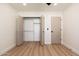 Spacious bedroom with light wood floors, ceiling fan, and closet space at 2178 E La Jolla Dr, Tempe, AZ 85282
