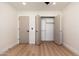 Spacious bedroom with light wood floors, ceiling fan, and large closet at 2178 E La Jolla Dr, Tempe, AZ 85282