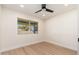 Bright bedroom with light wood floors, ceiling fan, and a view of the backyard at 2178 E La Jolla Dr, Tempe, AZ 85282