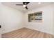 Bright bedroom with light wood floors, ceiling fan, and a view of the backyard at 2178 E La Jolla Dr, Tempe, AZ 85282