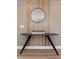 Stylish entryway featuring a modern console table, a round mirror, and decorative wooden accents at 2178 E La Jolla Dr, Tempe, AZ 85282