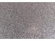 Close up of garage floor with gray epoxy finish with black and white decorative chips at 2178 E La Jolla Dr, Tempe, AZ 85282