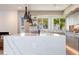 Kitchen island with quartz countertop and pendant lighting showcases a modern, open space at 2178 E La Jolla Dr, Tempe, AZ 85282