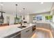 Spacious kitchen boasts a large island with seating, views of the backyard, and modern finishes at 2178 E La Jolla Dr, Tempe, AZ 85282