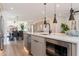 Open concept kitchen with a kitchen island and stainless steel appliances and a view to dining area at 2178 E La Jolla Dr, Tempe, AZ 85282