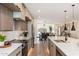 Open-concept kitchen with island, stainless steel appliances, and seamless flow to dining and living areas at 2178 E La Jolla Dr, Tempe, AZ 85282