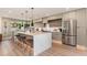 Bright kitchen showcases an island with seating, stainless steel refrigerator, and light wood flooring at 2178 E La Jolla Dr, Tempe, AZ 85282