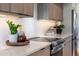 Bright kitchen with stone countertops, stainless steel appliances, and wood cabinets, offering modern charm at 2178 E La Jolla Dr, Tempe, AZ 85282