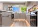 Contemporary kitchen with stone countertops, stainless steel appliances, wood cabinets, and recessed lighting at 2178 E La Jolla Dr, Tempe, AZ 85282