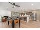 Spacious living area showcasing a modern kitchen, dining space, seating area, and foosball table at 2178 E La Jolla Dr, Tempe, AZ 85282