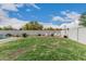 Spacious backyard featuring a grassy lawn, desert landscaping, and a fire pit area with seating at 21840 N 260Th Ln, Buckeye, AZ 85396