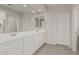 Bright bathroom with double sinks, white cabinets, and a large mirror at 21840 N 260Th Ln, Buckeye, AZ 85396