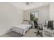 Bedroom with black office chair, desk, carpeted floors, and ceiling fan at 21840 N 260Th Ln, Buckeye, AZ 85396